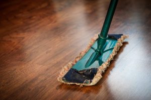 Shiny wood floors undergoing spring leaning with a mop