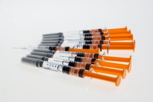 Row of syringes on a white table waiting to be used for non-surgical facelift Glasgow